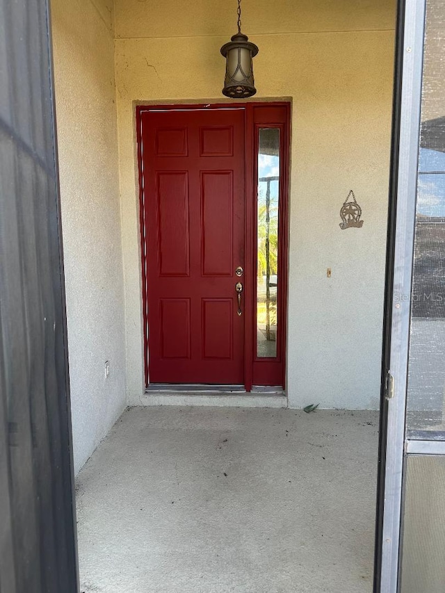 2704 Suncoast Lakes Blvd, Punta Gorda, FL 33980 - doorway to property with stucco siding