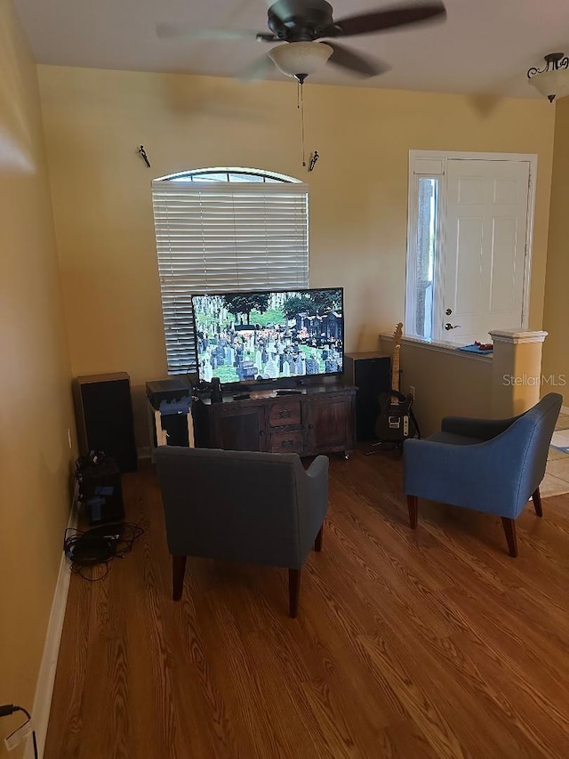 living room featuring ceiling fan, wood-type flooring, and plenty of natural light