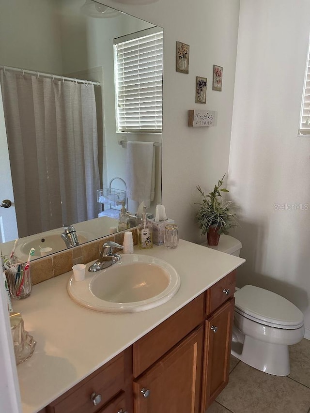 bathroom with vanity, toilet, and tile patterned floors