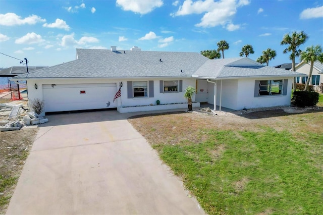 ranch-style home featuring a front lawn and a garage