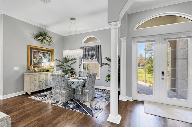 dining area featuring ornamental molding, french doors, dark hardwood / wood-style floors, and decorative columns