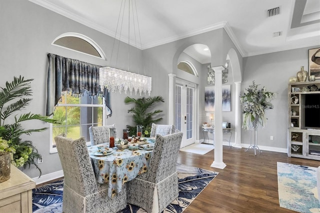 dining area with ornamental molding, dark hardwood / wood-style floors, a chandelier, and decorative columns