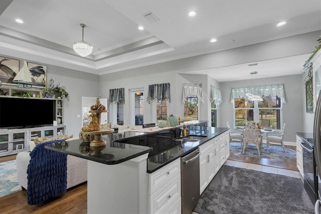 kitchen with dark hardwood / wood-style floors, crown molding, sink, a center island, and white cabinets