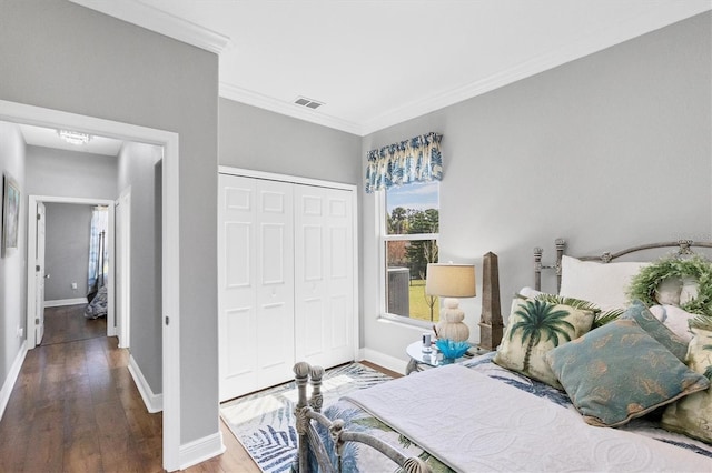 bedroom featuring a closet, crown molding, and hardwood / wood-style flooring