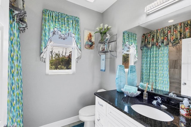 bathroom featuring vanity and toilet