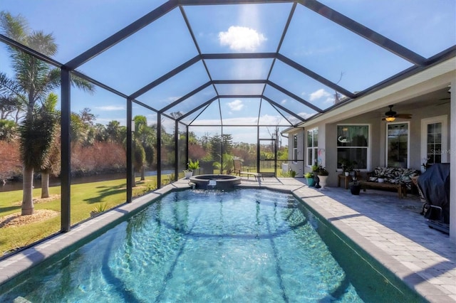 view of swimming pool featuring a patio, ceiling fan, glass enclosure, and an in ground hot tub