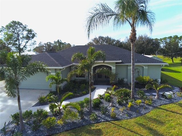 ranch-style home with a front yard and a garage