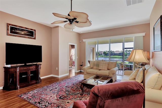 living room with hardwood / wood-style floors and ceiling fan