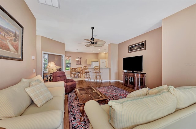 living room featuring hardwood / wood-style floors and ceiling fan