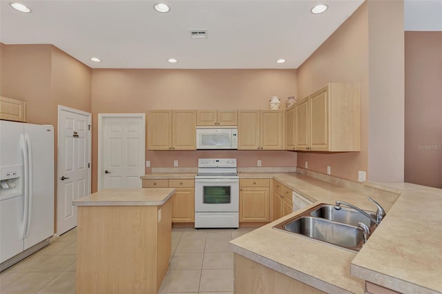 kitchen featuring sink, light brown cabinetry, light tile patterned floors, white appliances, and a kitchen island