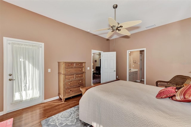 bedroom with hardwood / wood-style floors, ceiling fan, and connected bathroom