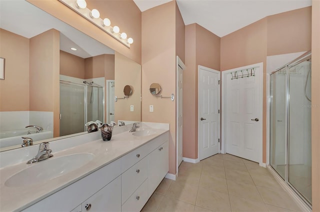 bathroom with vanity, tile patterned floors, and shower with separate bathtub