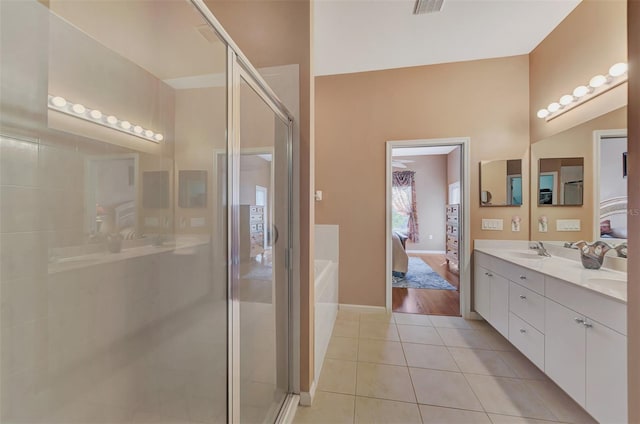 bathroom featuring vanity, tile patterned floors, and a shower with shower door