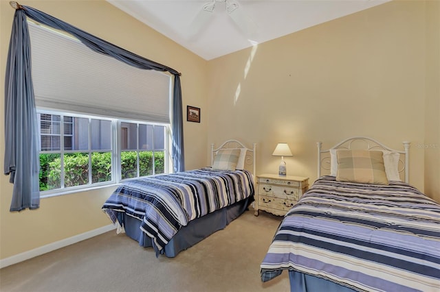 bedroom featuring light colored carpet and ceiling fan