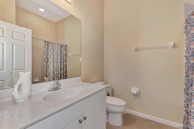 bathroom with toilet, curtained shower, vanity, and tile patterned floors