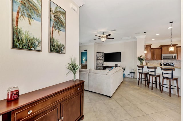 tiled living room with crown molding and ceiling fan