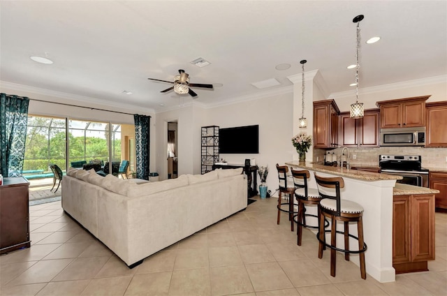 tiled living room with ceiling fan, ornamental molding, and sink