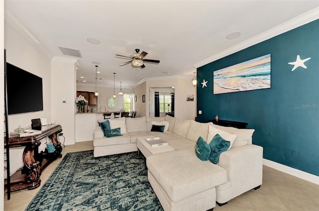 living room with light tile patterned flooring, ceiling fan, and ornamental molding