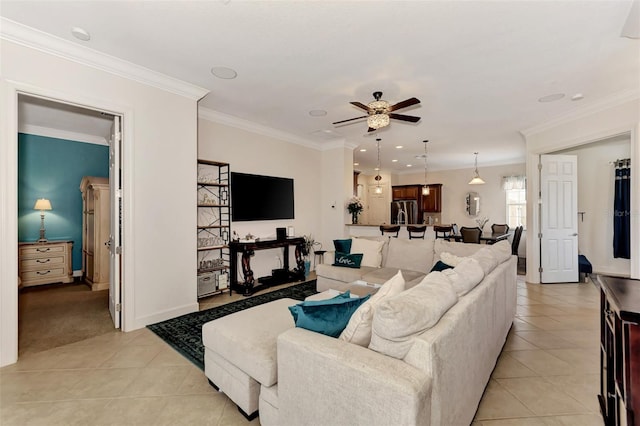 tiled living room with ornamental molding and ceiling fan