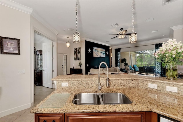 kitchen featuring sink, hanging light fixtures, light tile patterned floors, ceiling fan, and crown molding