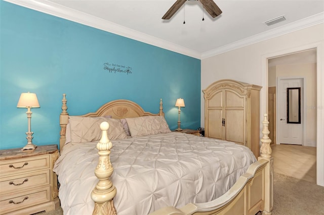 bedroom with ceiling fan, ornamental molding, and light carpet