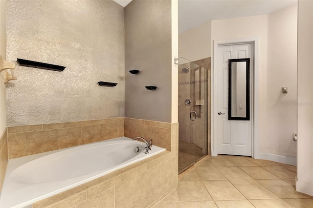 bathroom with tile patterned flooring and shower with separate bathtub