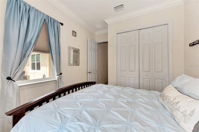 bedroom with ornamental molding and a closet