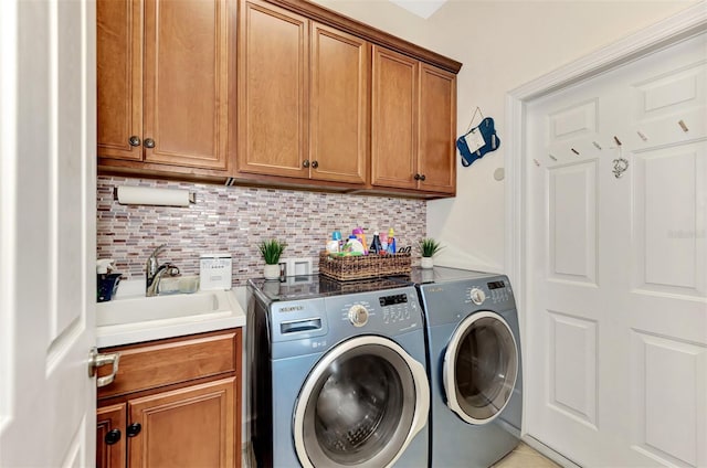 laundry area featuring sink, cabinets, washing machine and clothes dryer, and light tile patterned flooring