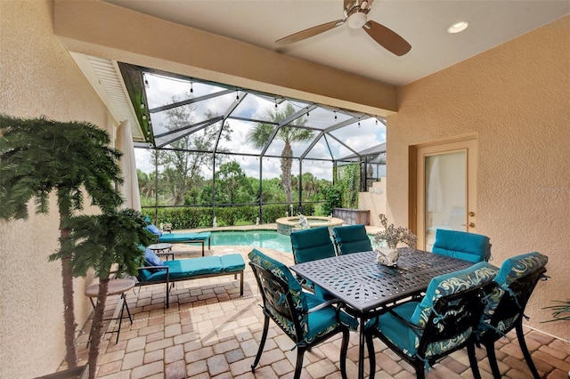 view of patio with ceiling fan and an in ground hot tub