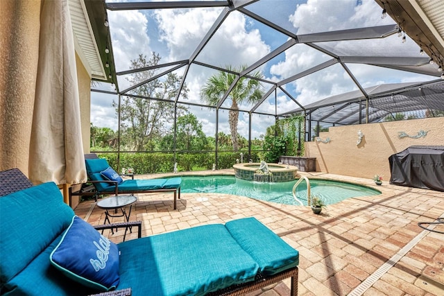 view of pool with an in ground hot tub, glass enclosure, and a patio area