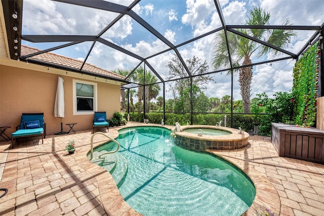 view of pool featuring an in ground hot tub, a patio area, and glass enclosure