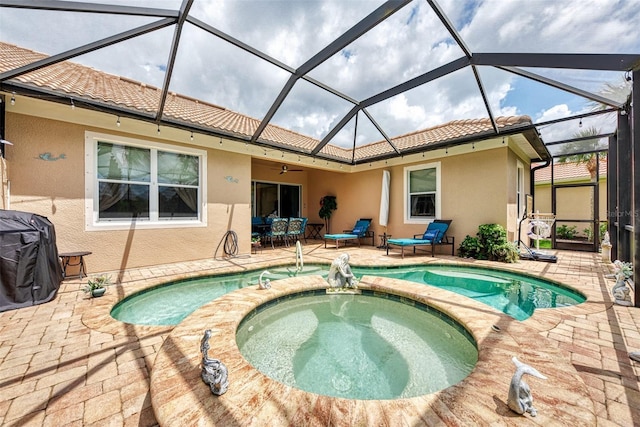 rear view of house with a patio area, glass enclosure, and a pool with hot tub