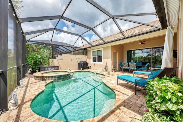 view of pool with an in ground hot tub, area for grilling, ceiling fan, and a patio