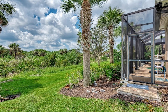 view of yard with glass enclosure