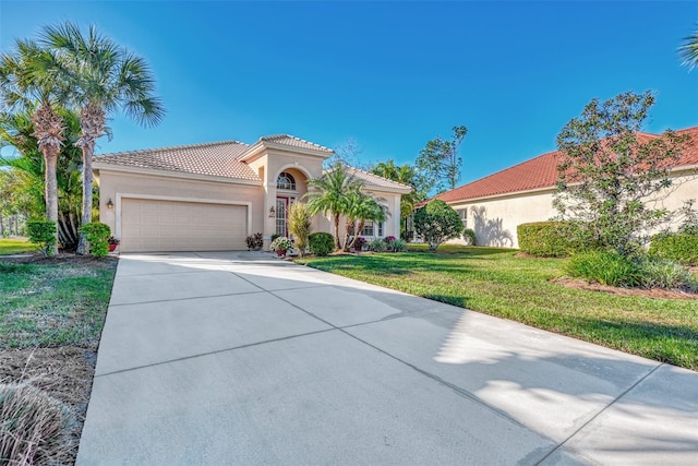 mediterranean / spanish-style house featuring a garage and a front yard