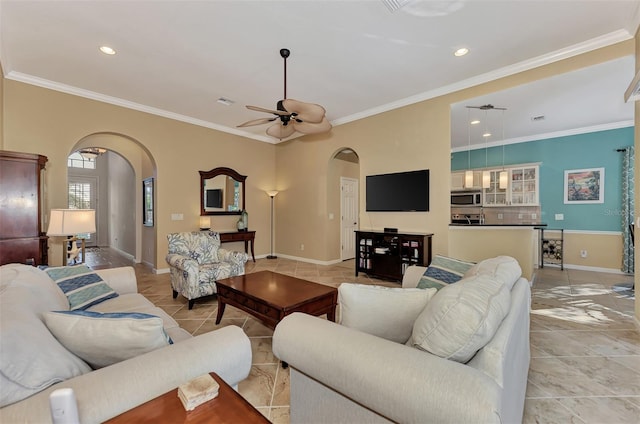 tiled living room with ornamental molding and ceiling fan