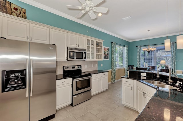 kitchen featuring white cabinets, sink, backsplash, and appliances with stainless steel finishes