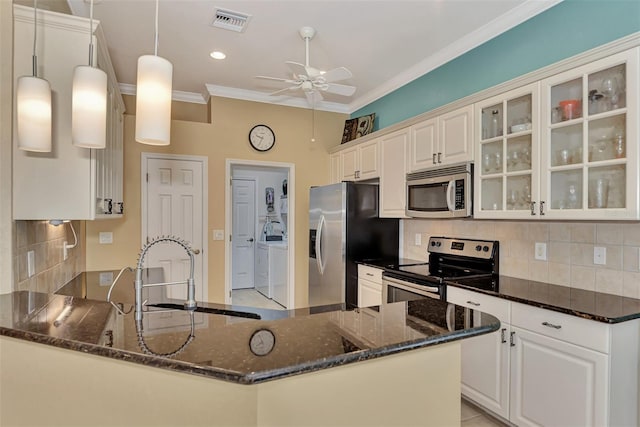 kitchen with white cabinets, appliances with stainless steel finishes, hanging light fixtures, and sink