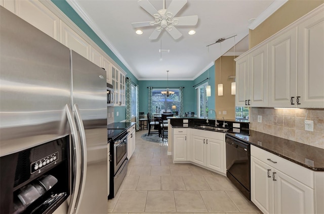 kitchen featuring white cabinetry, sink, black appliances, light tile patterned floors, and hanging light fixtures