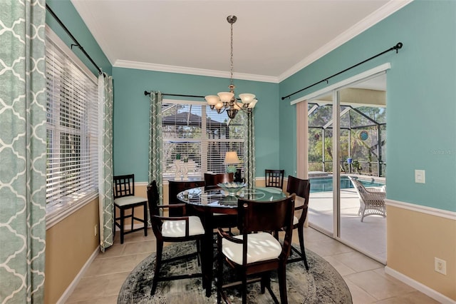 tiled dining space with ornamental molding, plenty of natural light, and a notable chandelier