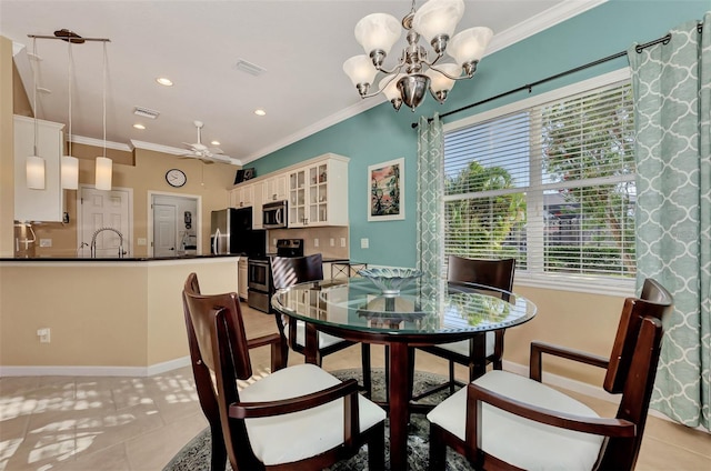 tiled dining space with ornamental molding, ceiling fan with notable chandelier, and sink