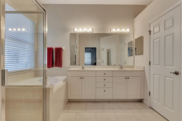 bathroom featuring independent shower and bath, vanity, and tile patterned flooring