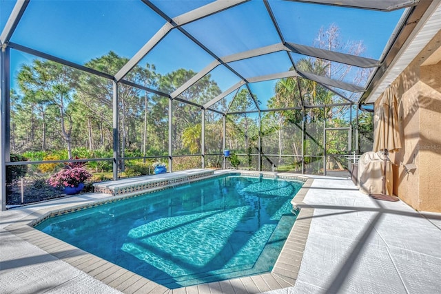 view of pool with a lanai and a patio