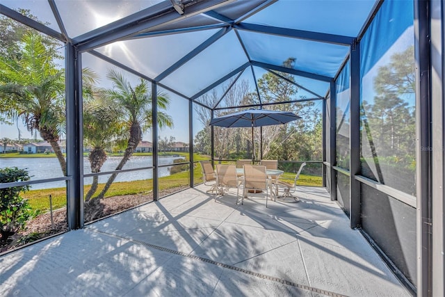 unfurnished sunroom with a wealth of natural light, a water view, and vaulted ceiling