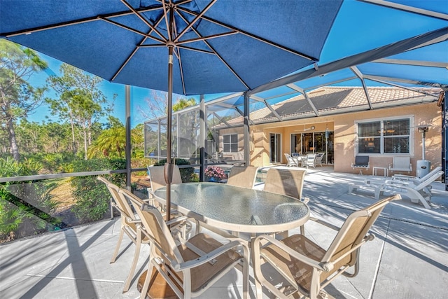 view of patio with glass enclosure