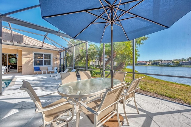 view of patio / terrace with a water view and glass enclosure