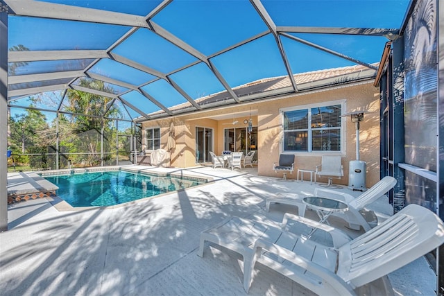 view of pool featuring ceiling fan, a lanai, and a patio area