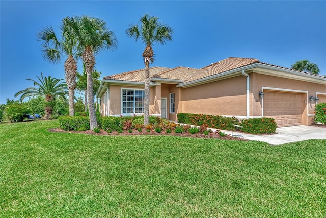 mediterranean / spanish-style house with a garage and a front lawn