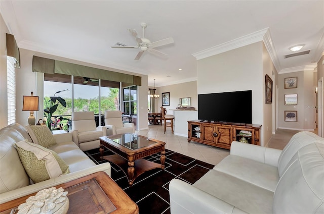 tiled living room featuring ceiling fan with notable chandelier and crown molding