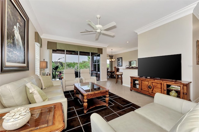 tiled living room with ceiling fan with notable chandelier and ornamental molding